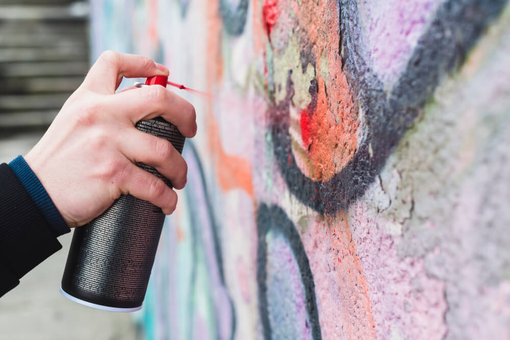 man-s-hand-spraying-red-paint-with-spray-bottle
